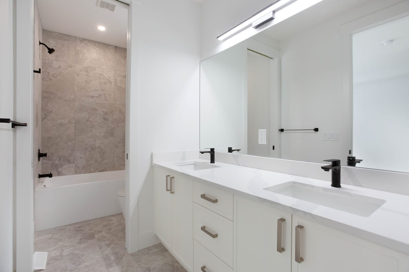 Full bathroom with vanity and bathtub — supplied paired-home gallery; confirm 1106 finishes