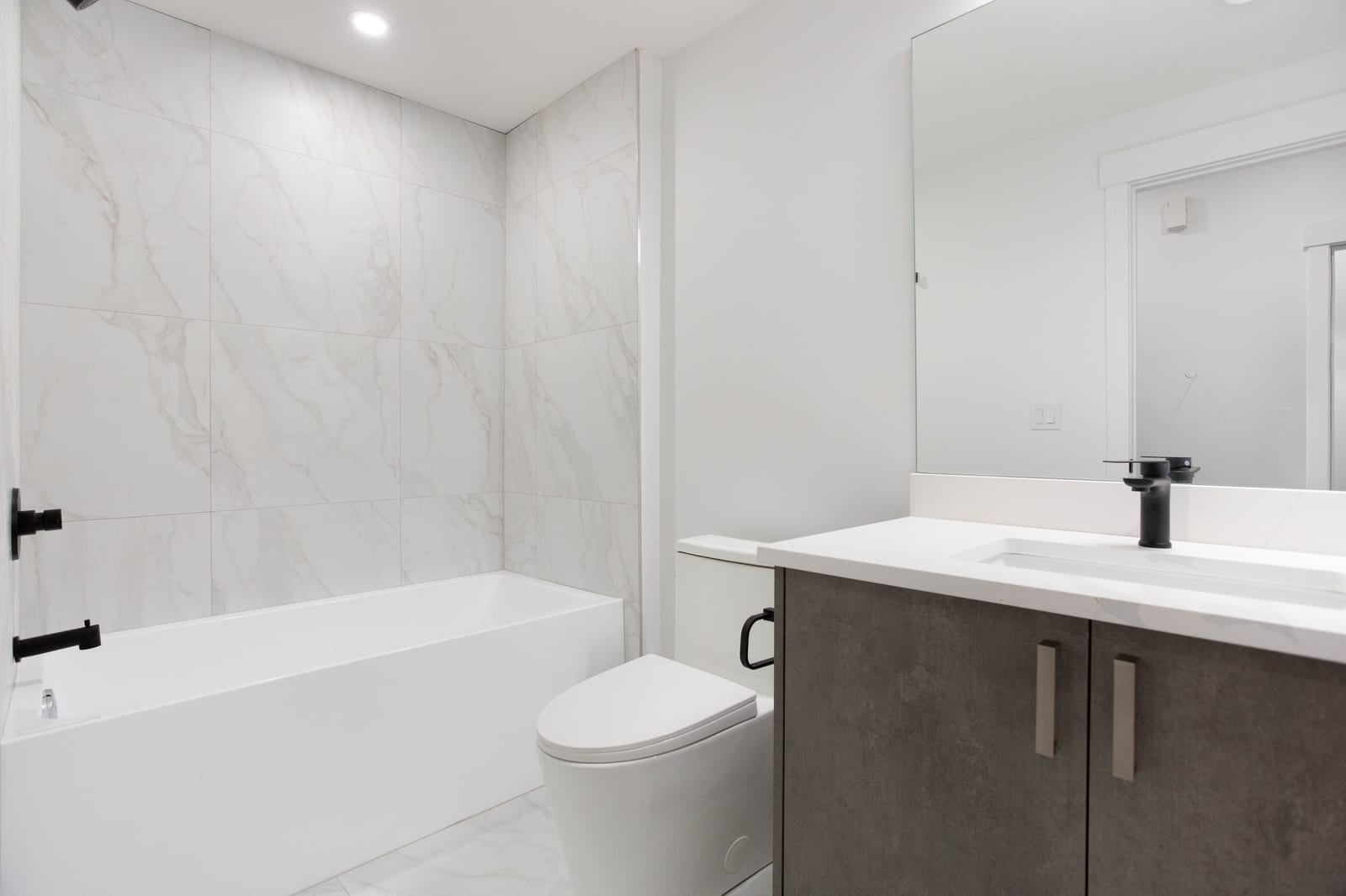 Lower-level full bathroom — supplied paired-home gallery; confirm 1106 finishes