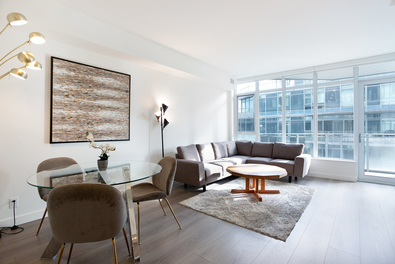 Open dining and living area with broad windows