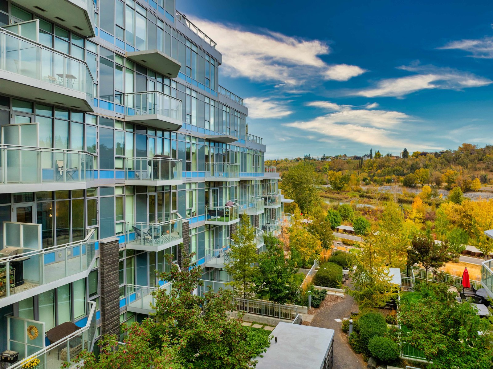 Aerial view of Waterfront balconies and river-side trees