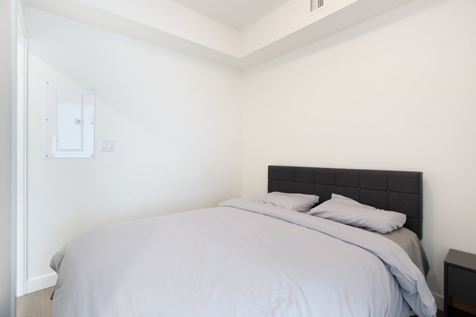 Bedroom with closet doors and recessed ceiling