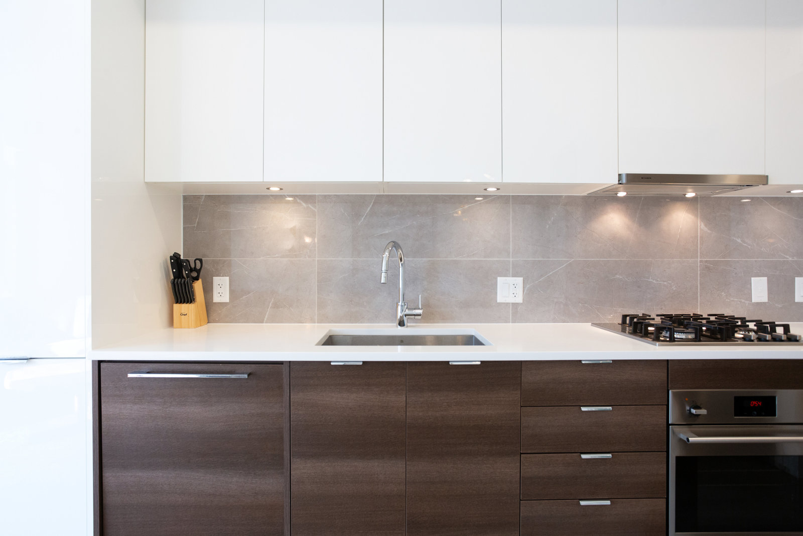Two-tone kitchen with full-height cabinetry