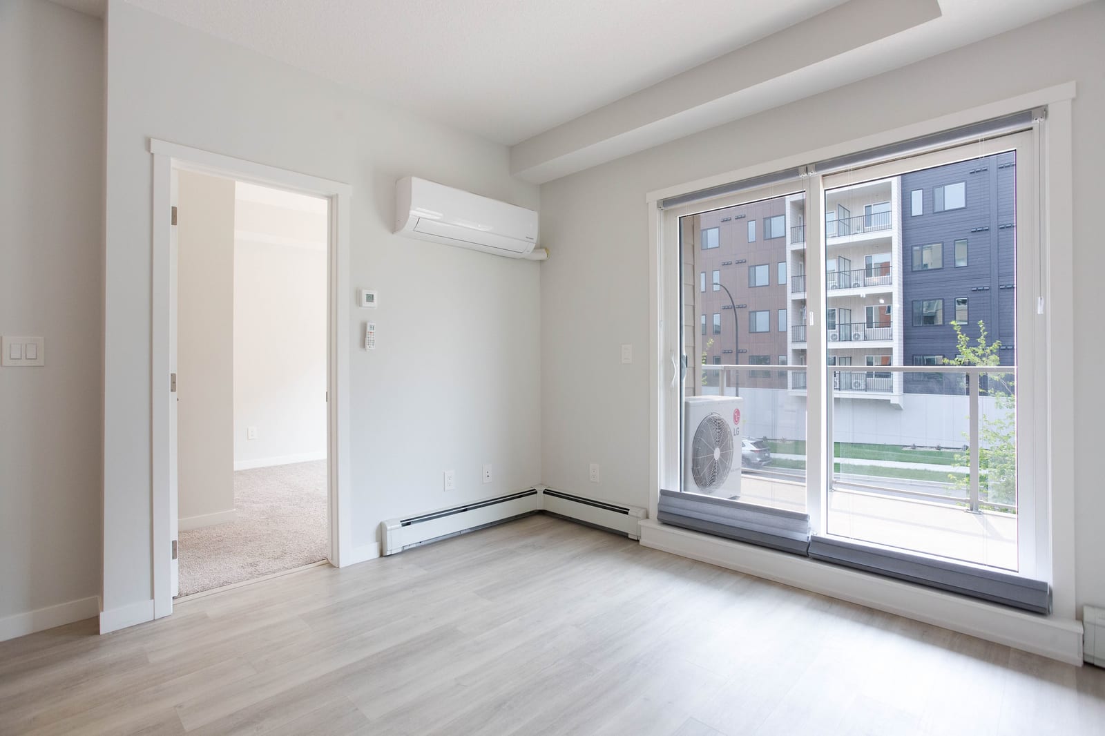 The unfurnished living room and balcony doors